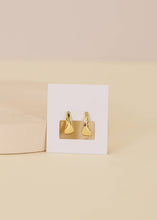 Load image into Gallery viewer, Gold earrings on a Jaxkelly branded card against a beige background