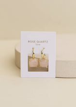 Load image into Gallery viewer, Jaxkelly rose quartz earrings on a display card against a beige background