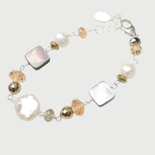 Load image into Gallery viewer, A beaded bracelet featuring baroque pearls, square iridescent mother-of-pearl beads, faceted peach crystal beads, and silver-toned links, displayed on a white ceramic plate.
